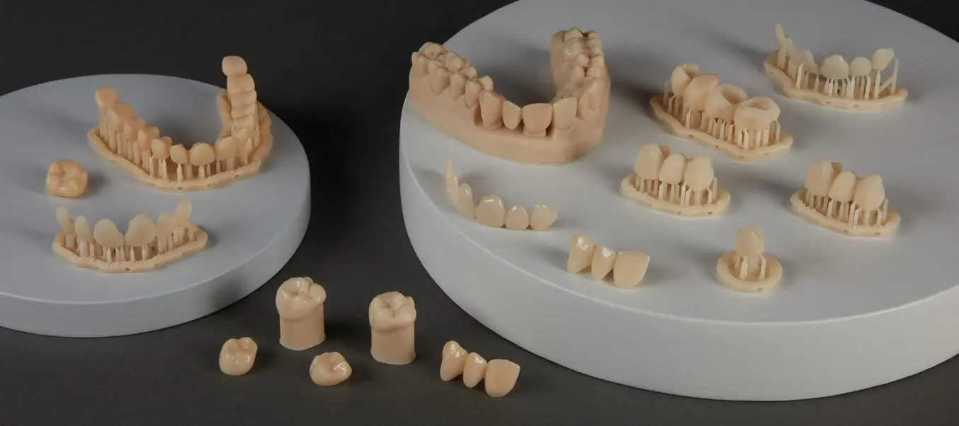 Parts printed with BEGO™ VarseoSmileⓇ TriniQⓇ Resin including veneers, three-unit bridges, and crowns