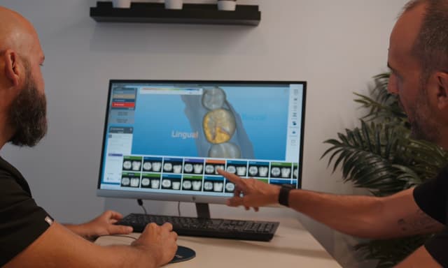 Two men looking at a computer screen