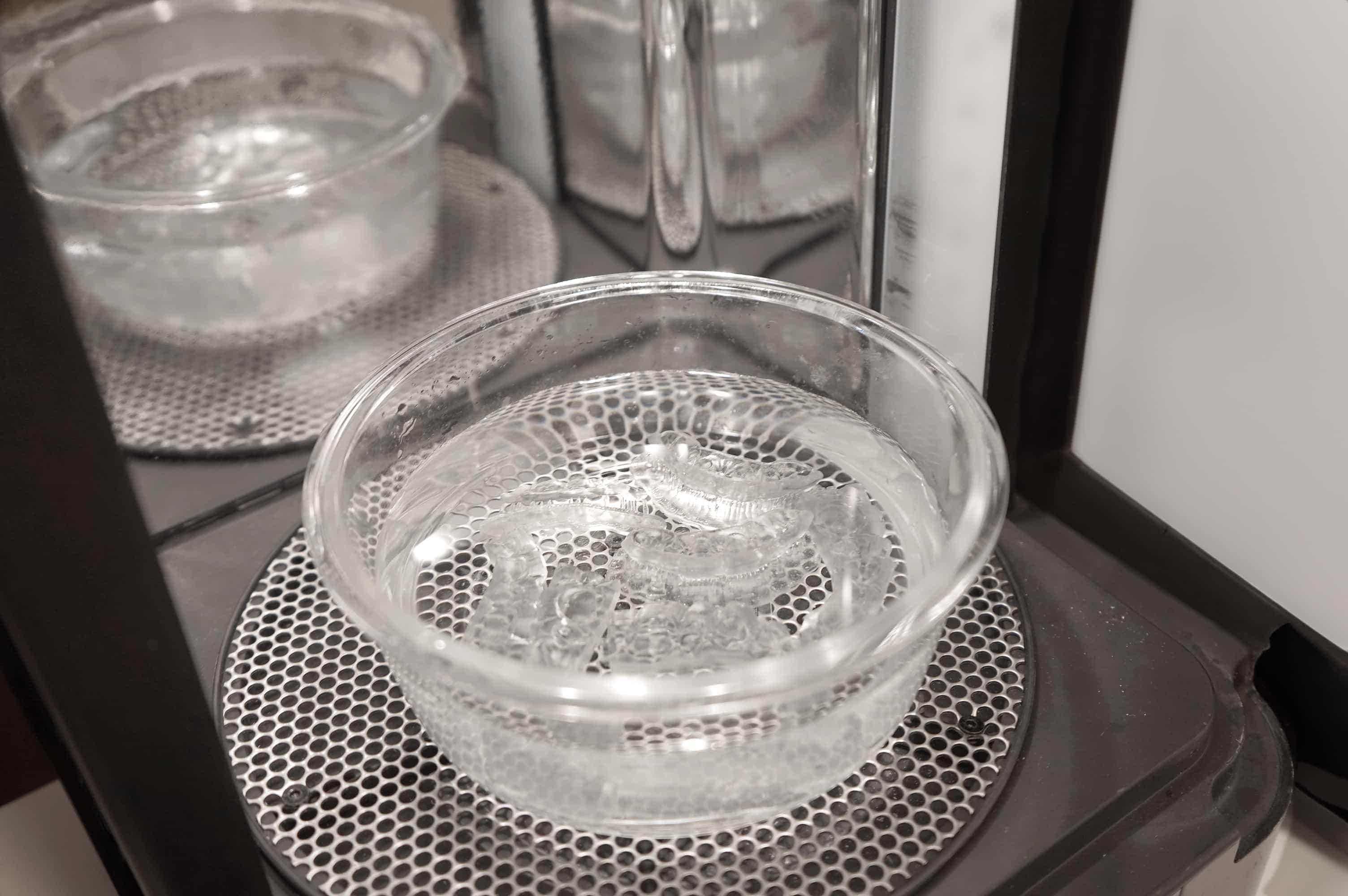 Printed parts submerged in a transparent, water-filled container