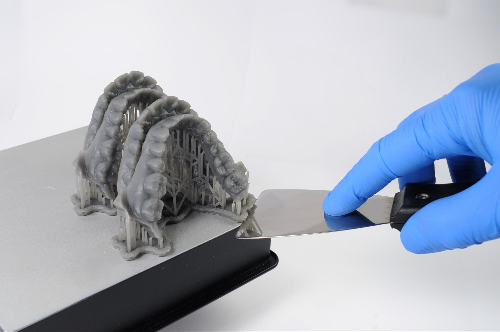 scraping tool under the edge of the support raft