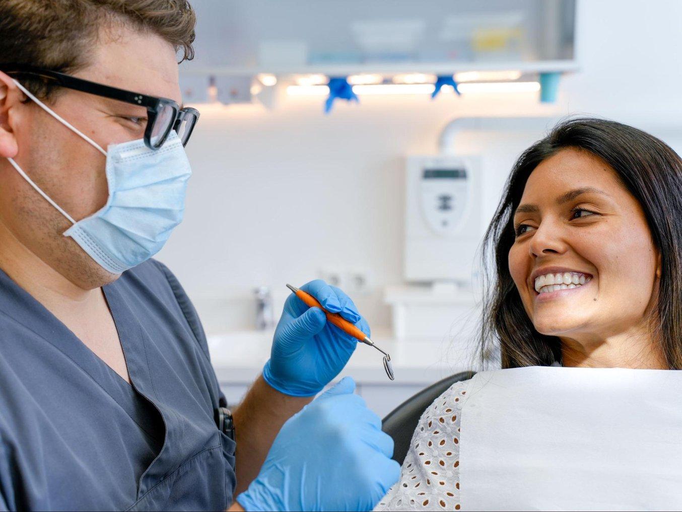 doctor placing a clear aligner on a patient
