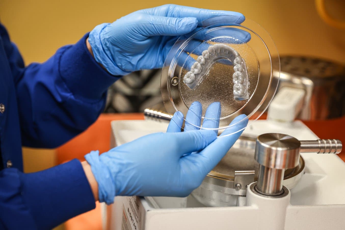Gloved hands holding a thermoformed model