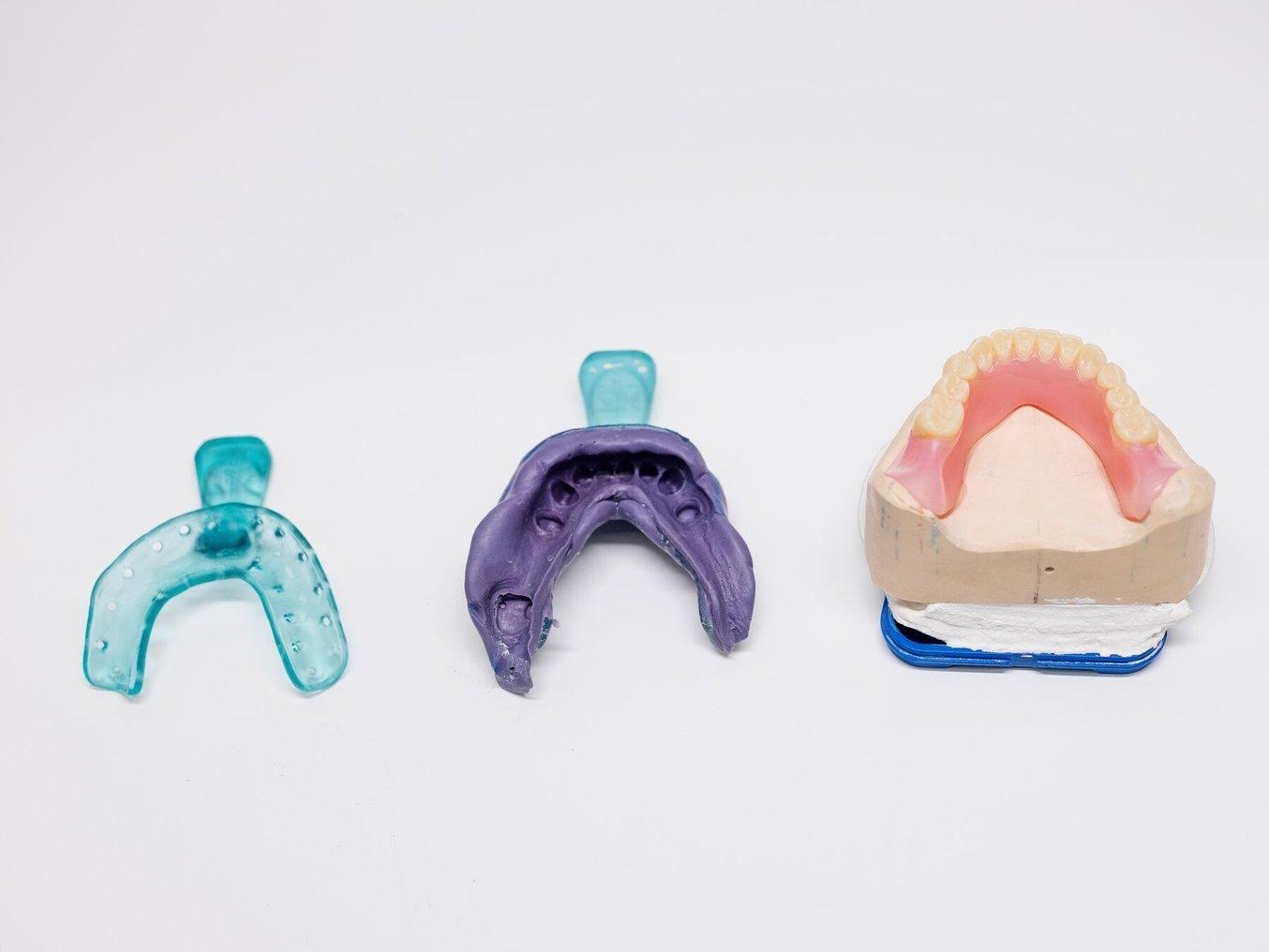 Two custom impression trays and finished mandibular denture