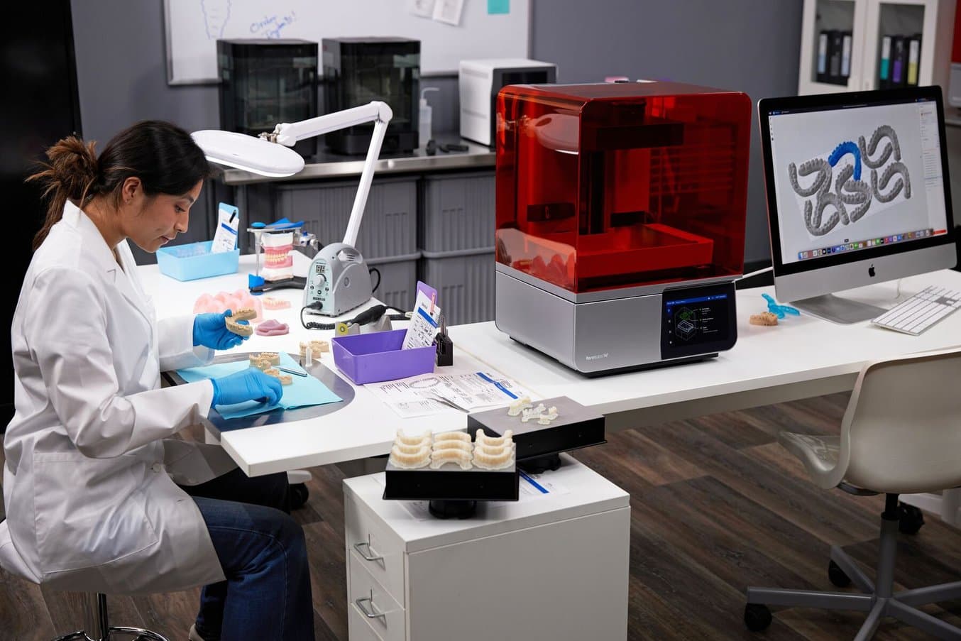 Dental professional seated at a desk next to Form 4B