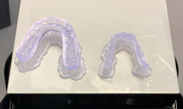 Printer occlusal splint and Kois Deprogrammer on a build platform..