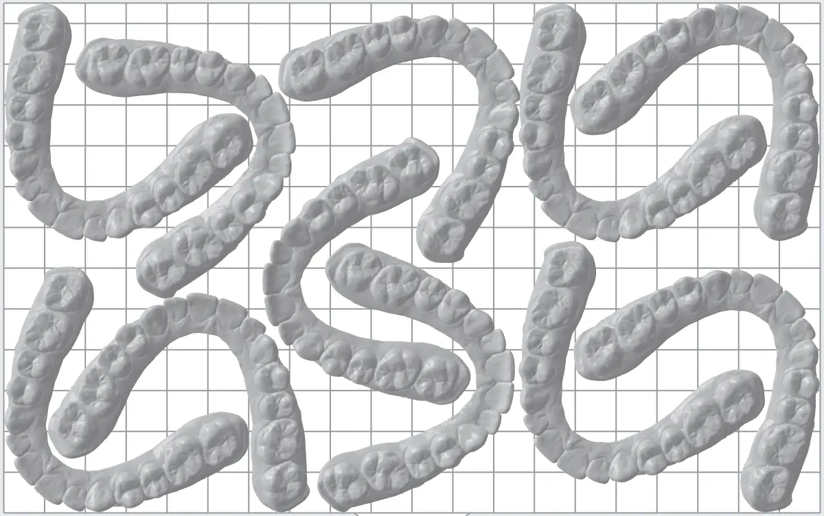 11 dental models on a build platform in PreForm