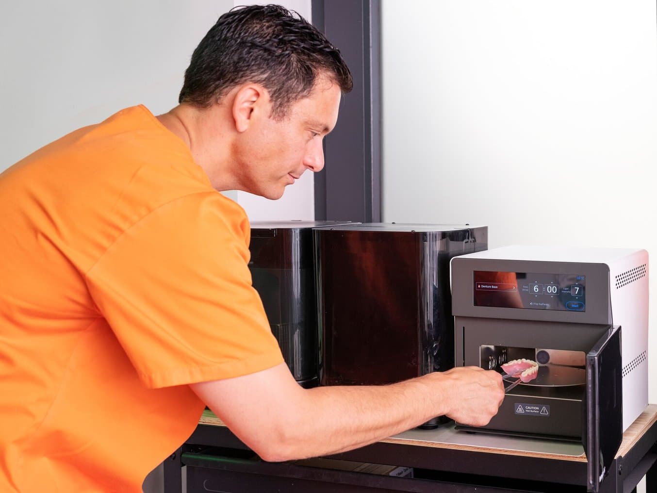 Dental technician creating 3D printed dentures