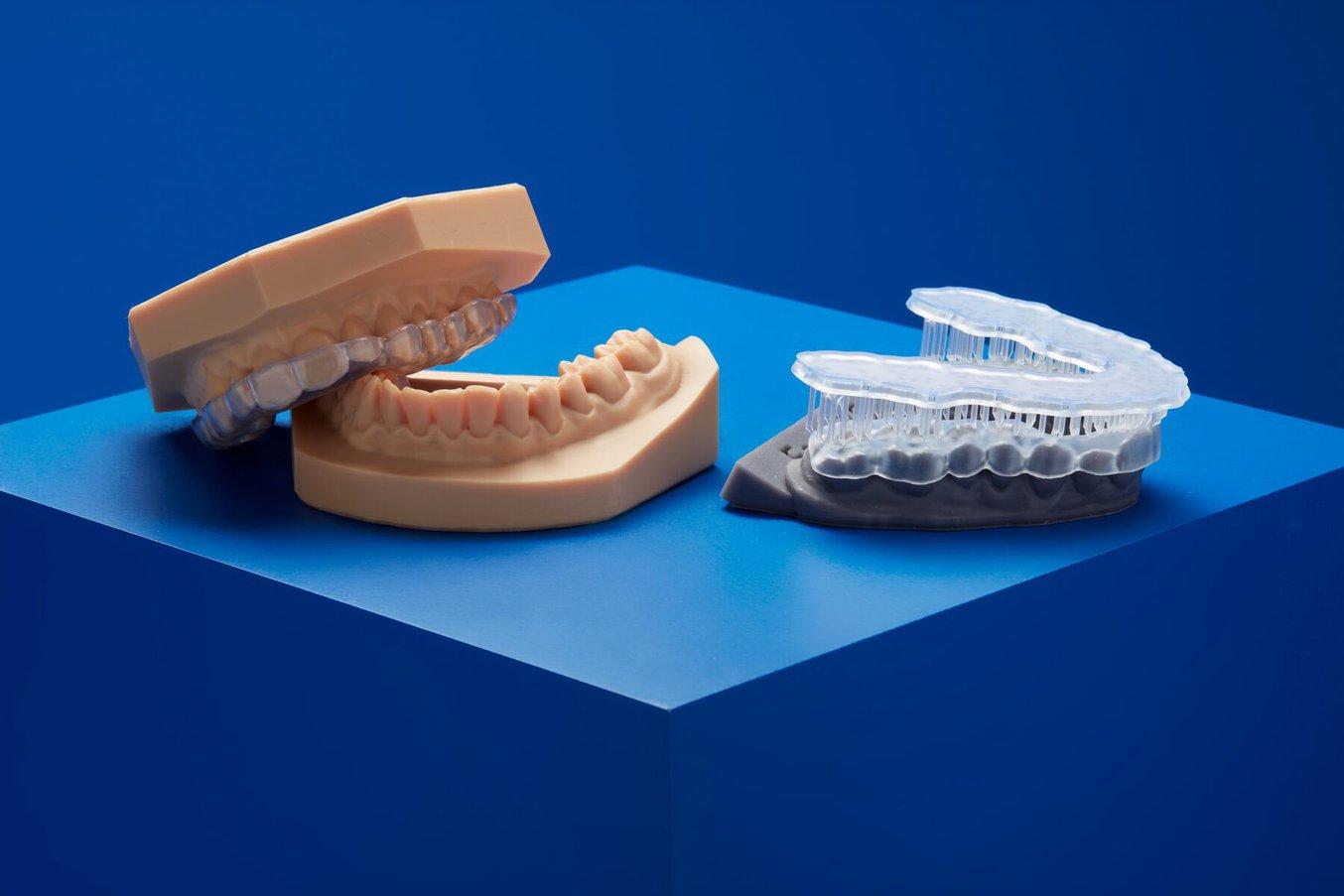 Two dental models 3D printed on Dental LT Clear Resin (V2) on a blue background