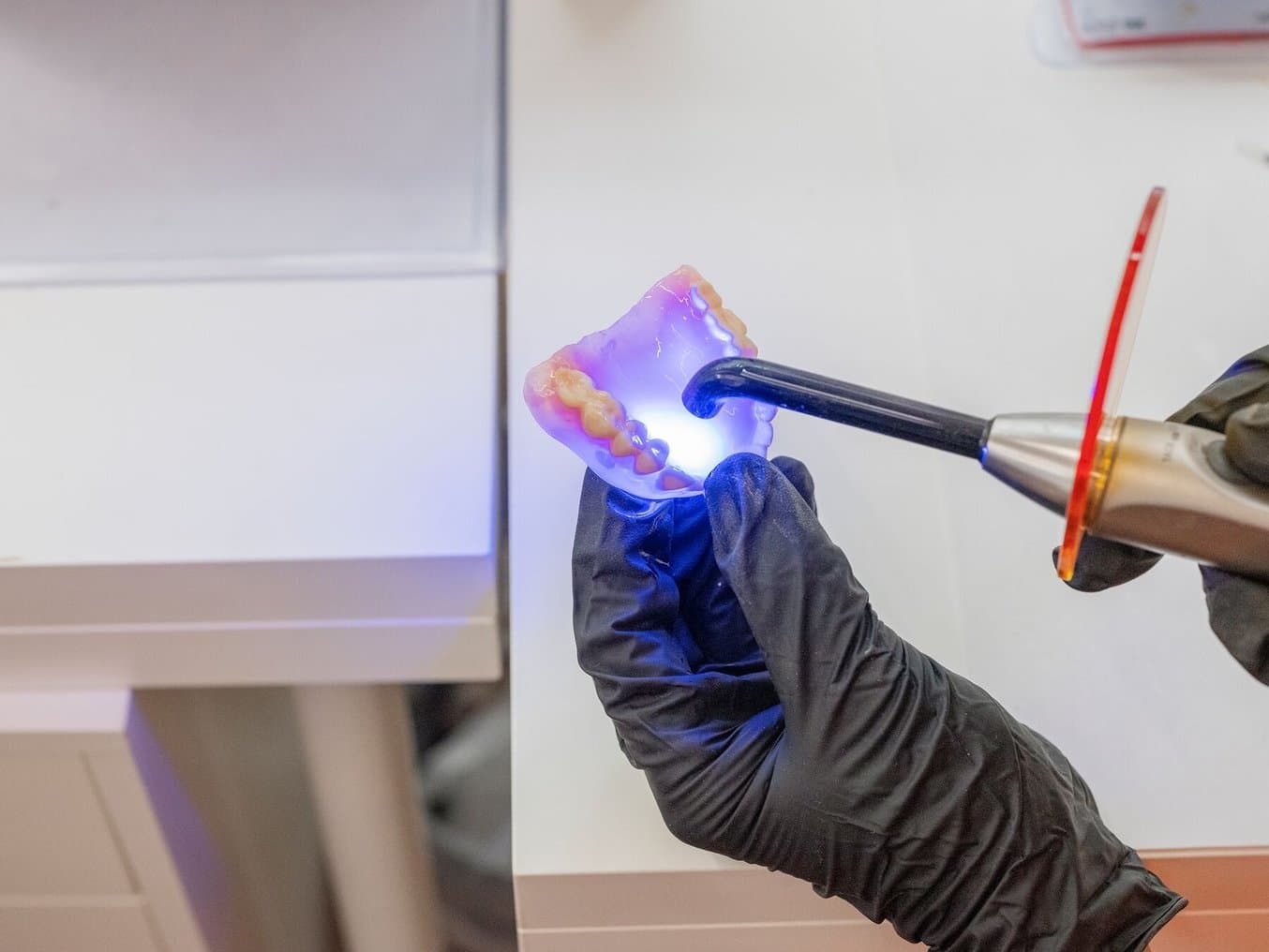 Using a polymerization lamp to create dentures