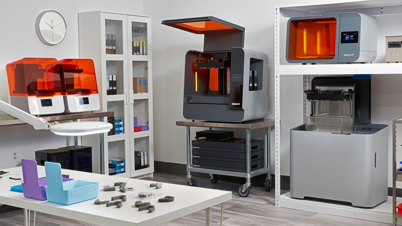 A room fully stocked with Formlabs Dental products: The Form 3BL, Form 3B+, Wash Cure L, Cure L, and multiple dental resins.