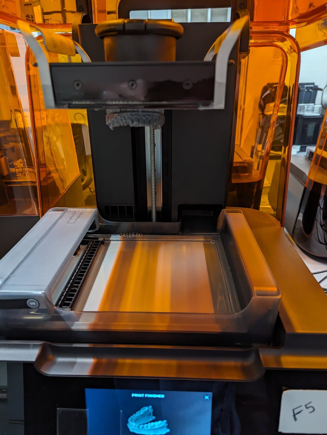 Dental model on a build platform inside a Form 3+ 3D printer.